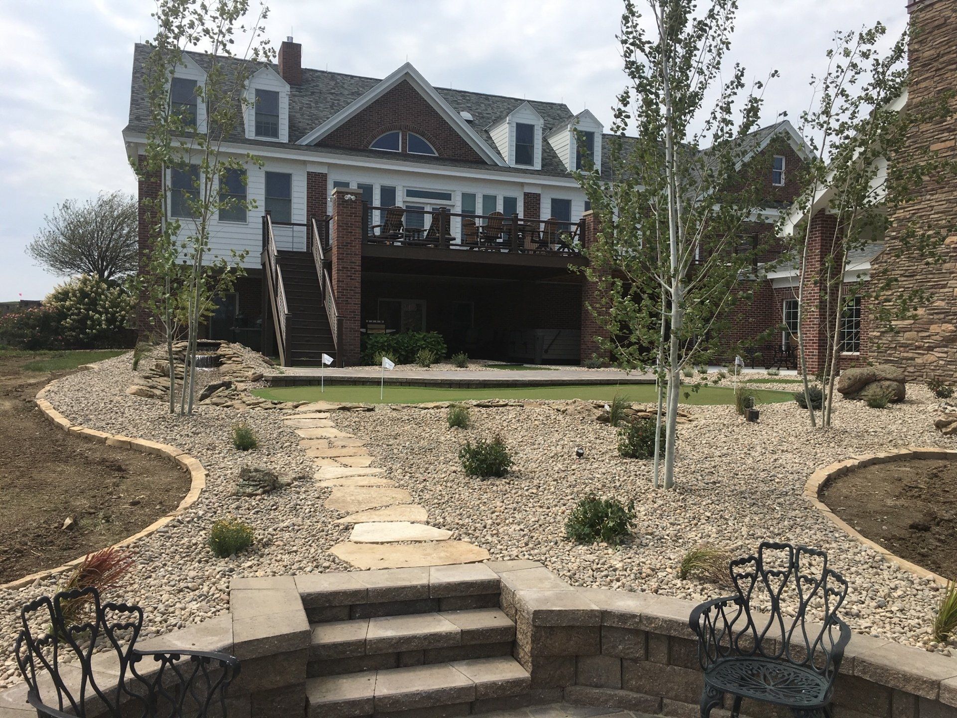 A large house with a fire pit in front of it