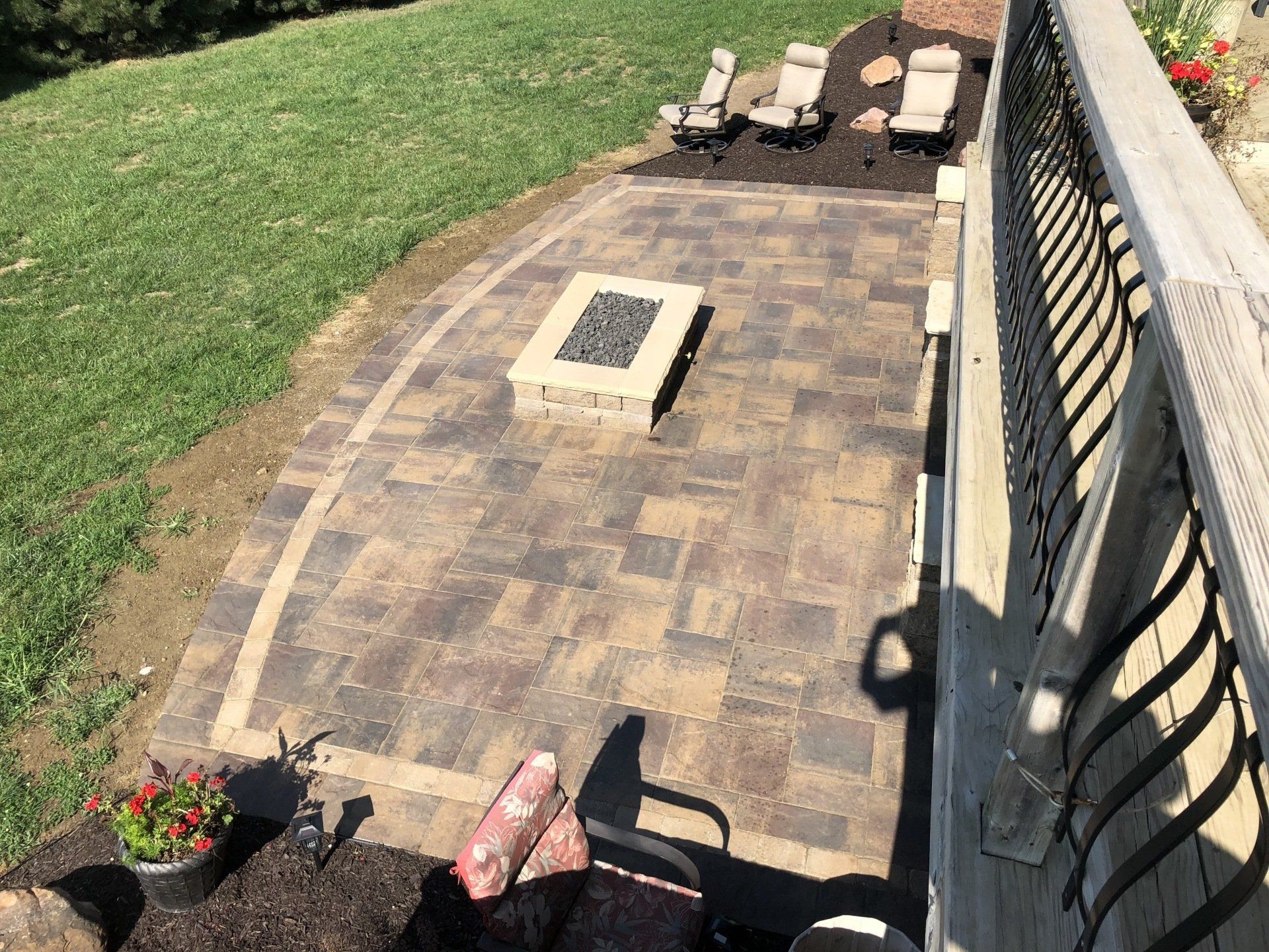 There is a fire pit in the middle of the patio.