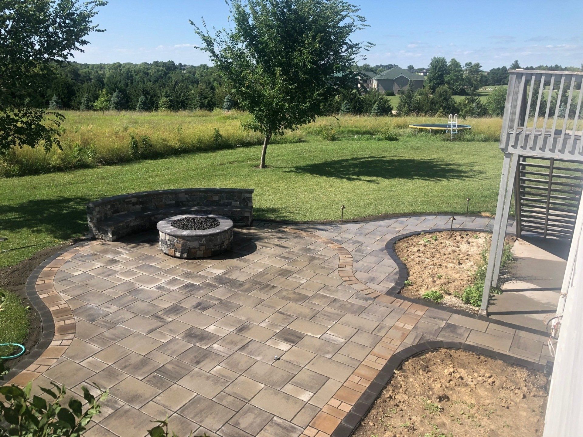 There is a fire pit in the middle of the patio.