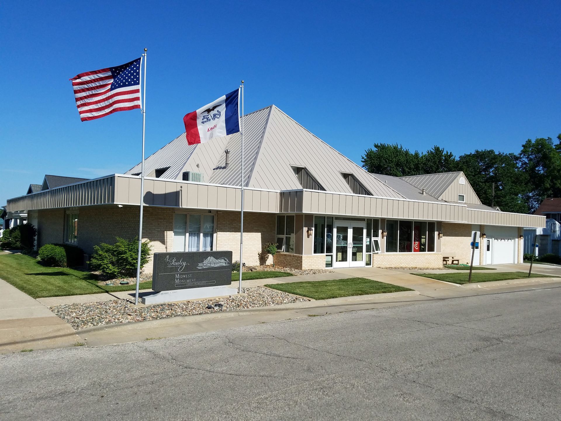 An american flag is flying in front of a building