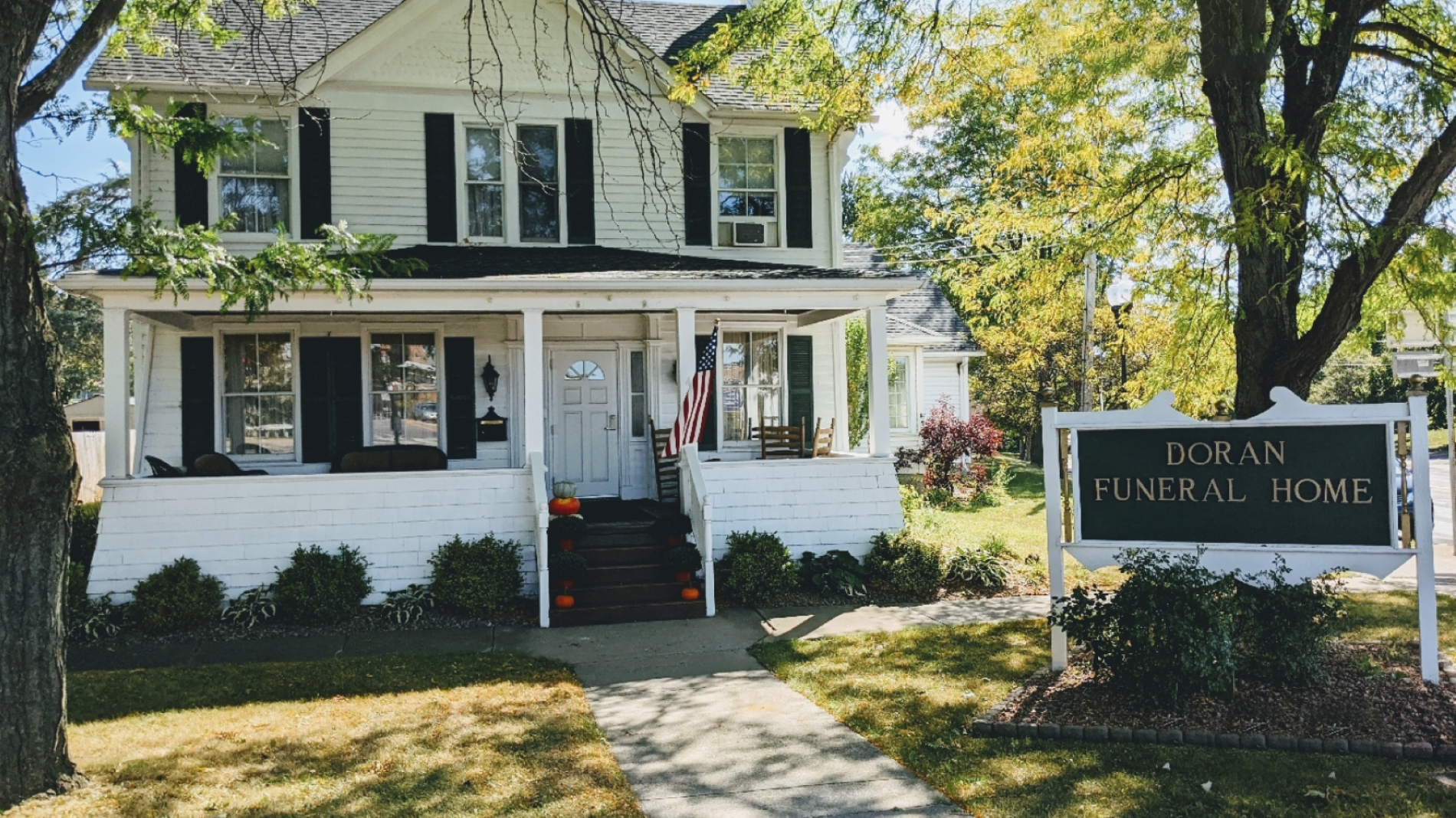a brick building with a black awning that says funeral home