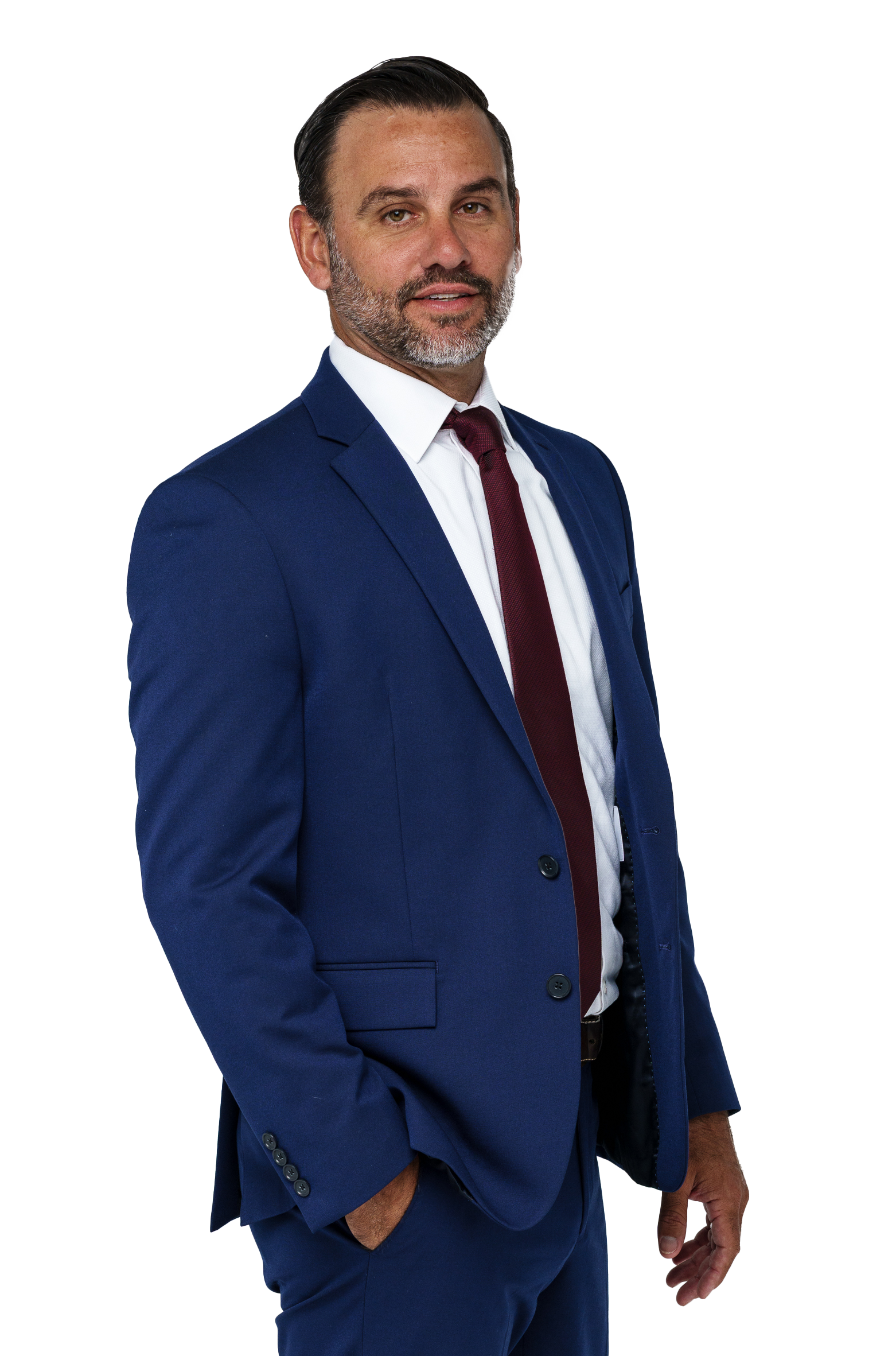 A man with a beard wearing a blue suit and red tie.