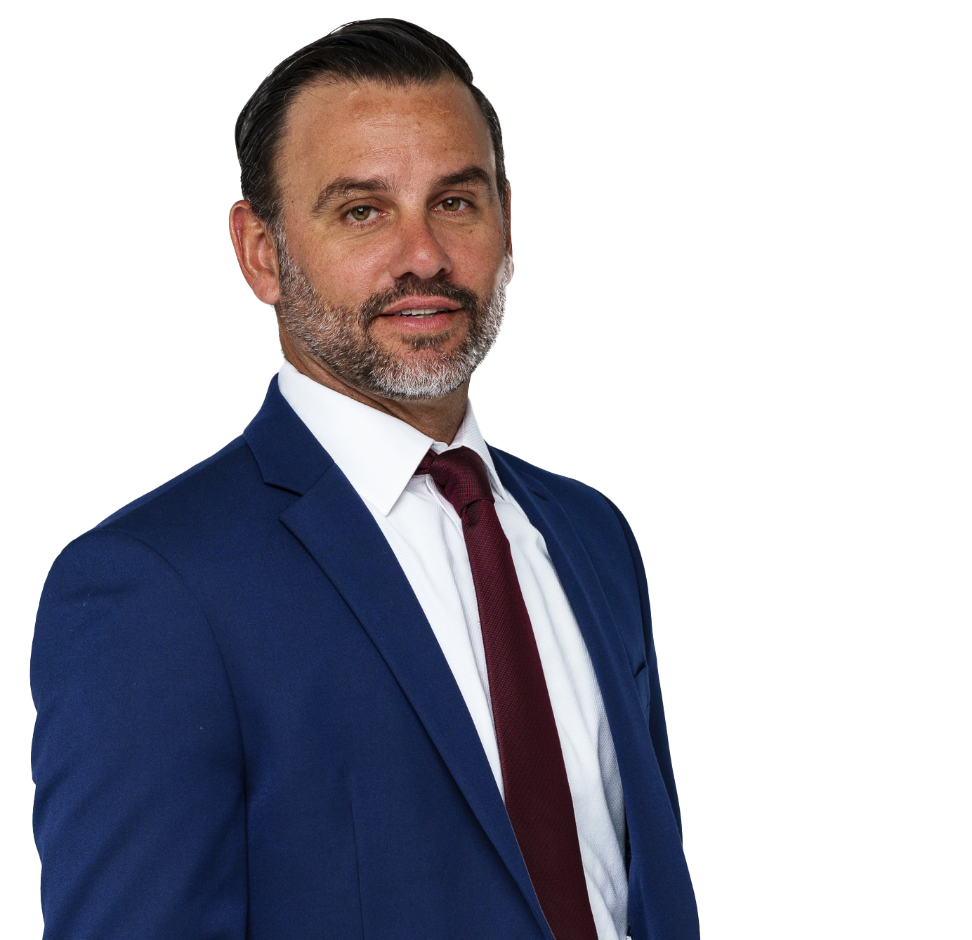A man with a beard wearing a blue suit and red tie.