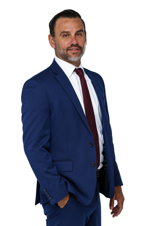 A man with a beard wearing a blue suit and red tie.