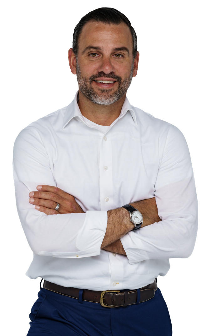 A man in a suit and tie is standing in front of a white background.