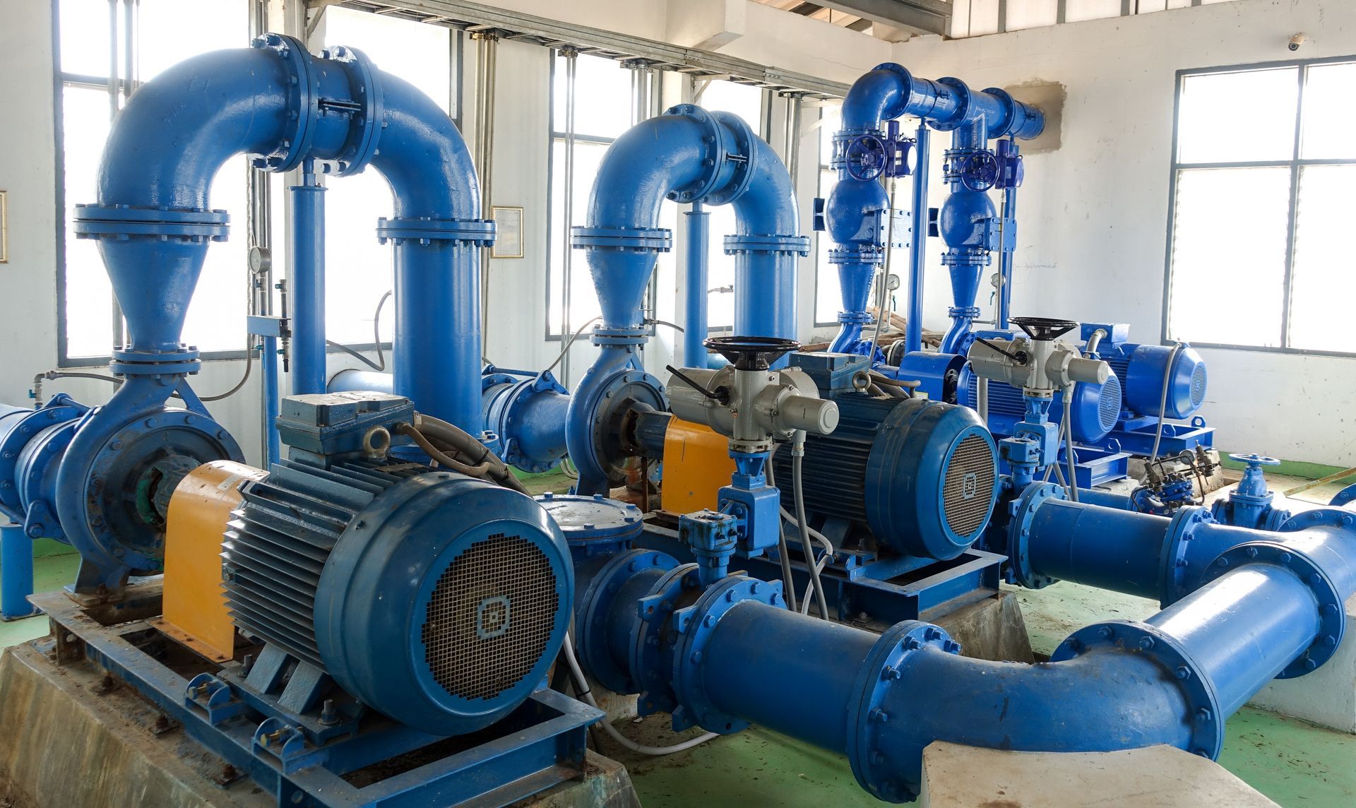 Water pump system with electric motors and blue piping used for water pump repair service Water pump system with electric motors and blue piping used for water pump repair service