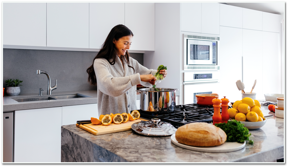 A woman is preparing food in a kitchen.