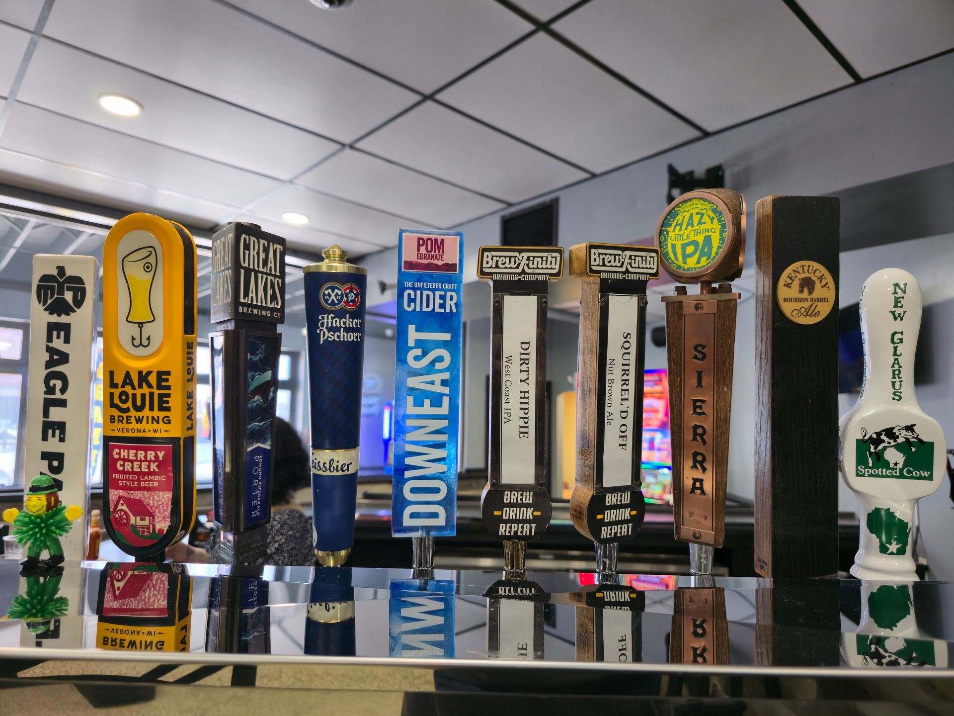 A cheeseburger with lettuce, tomato, and red onion on a wooden cutting board.