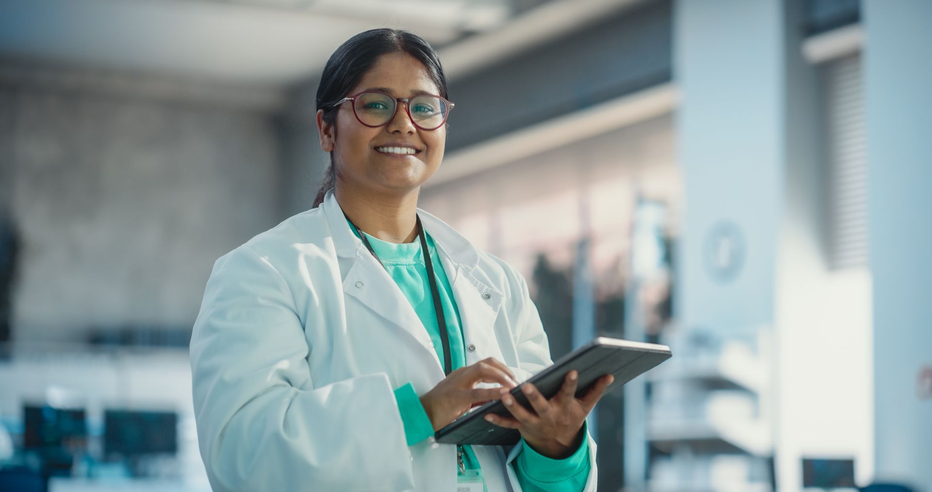 A female doctor is using a tablet computer in a hospital.