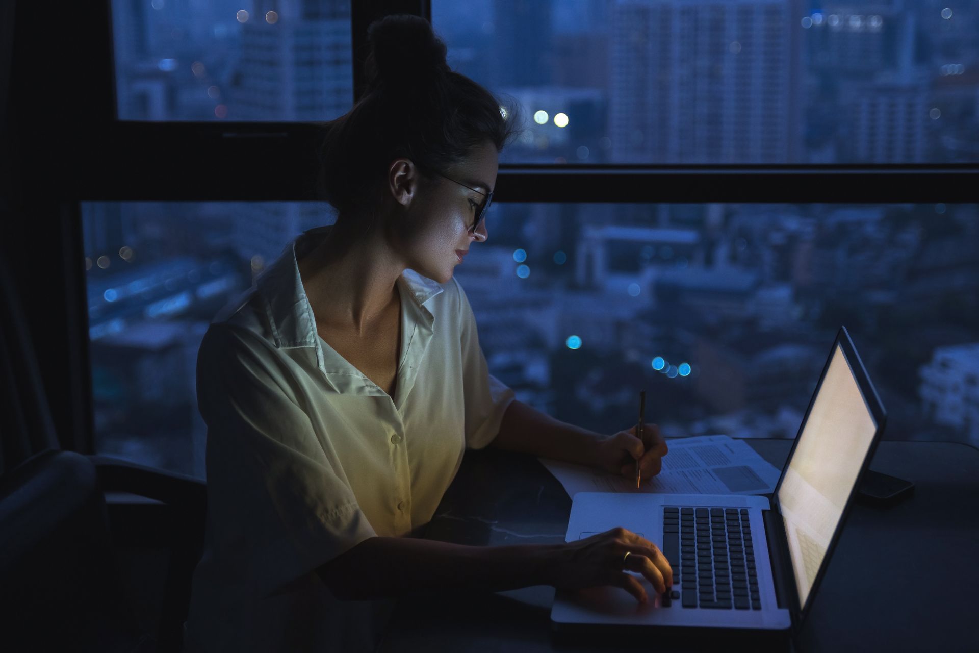 A man and a woman are looking at a computer screen.