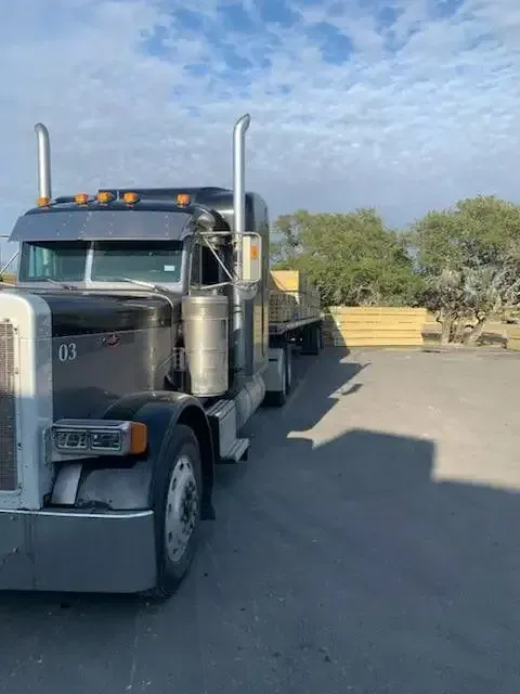 A semi truck is parked in a parking lot.