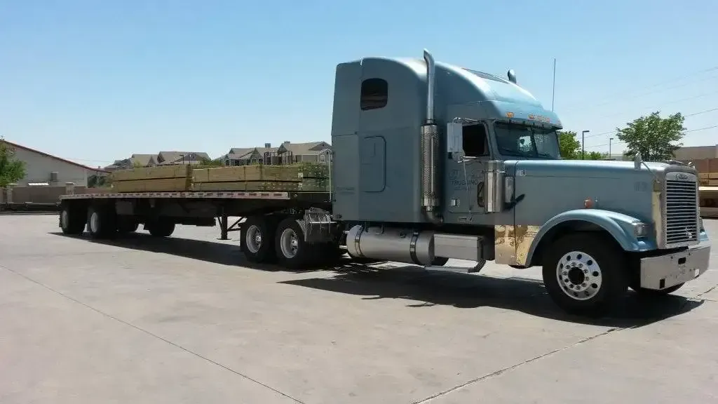 A large semi truck is parked in a parking lot.