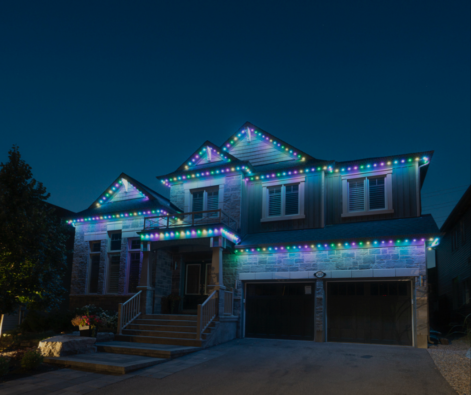 House decorated with colorful Christmas lights at night.