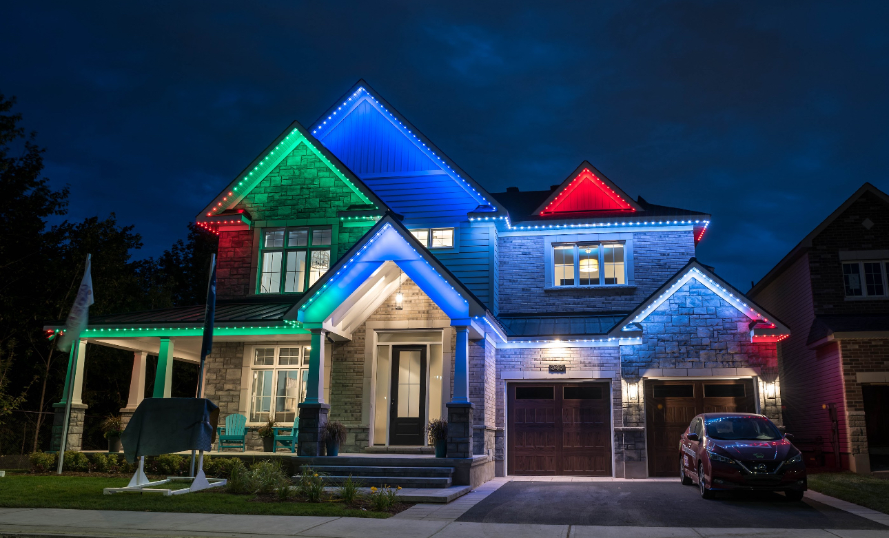 House decorated with colorful Christmas lights at night.
