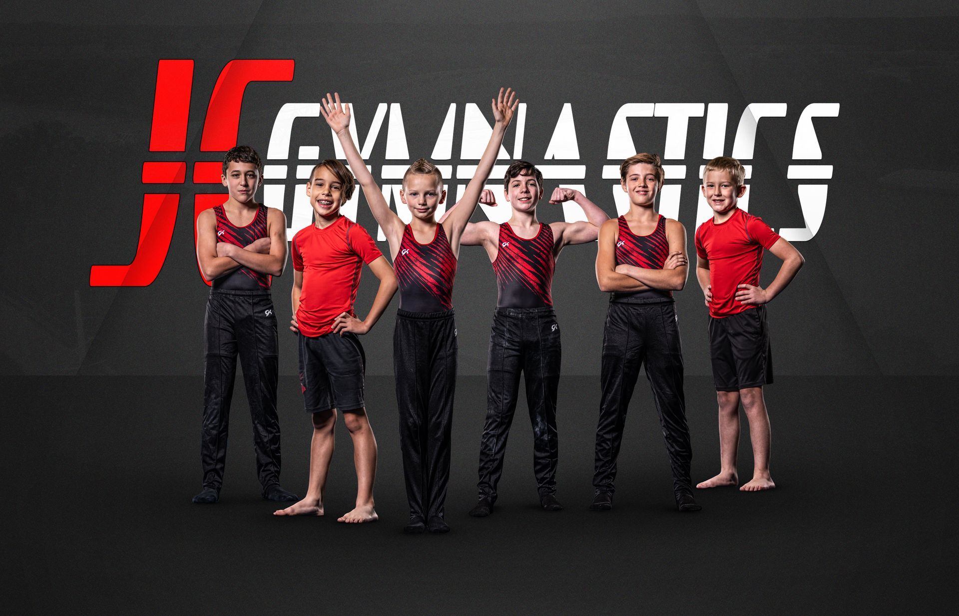 A group of young boys are standing next to each other in front of a gymnastics logo.