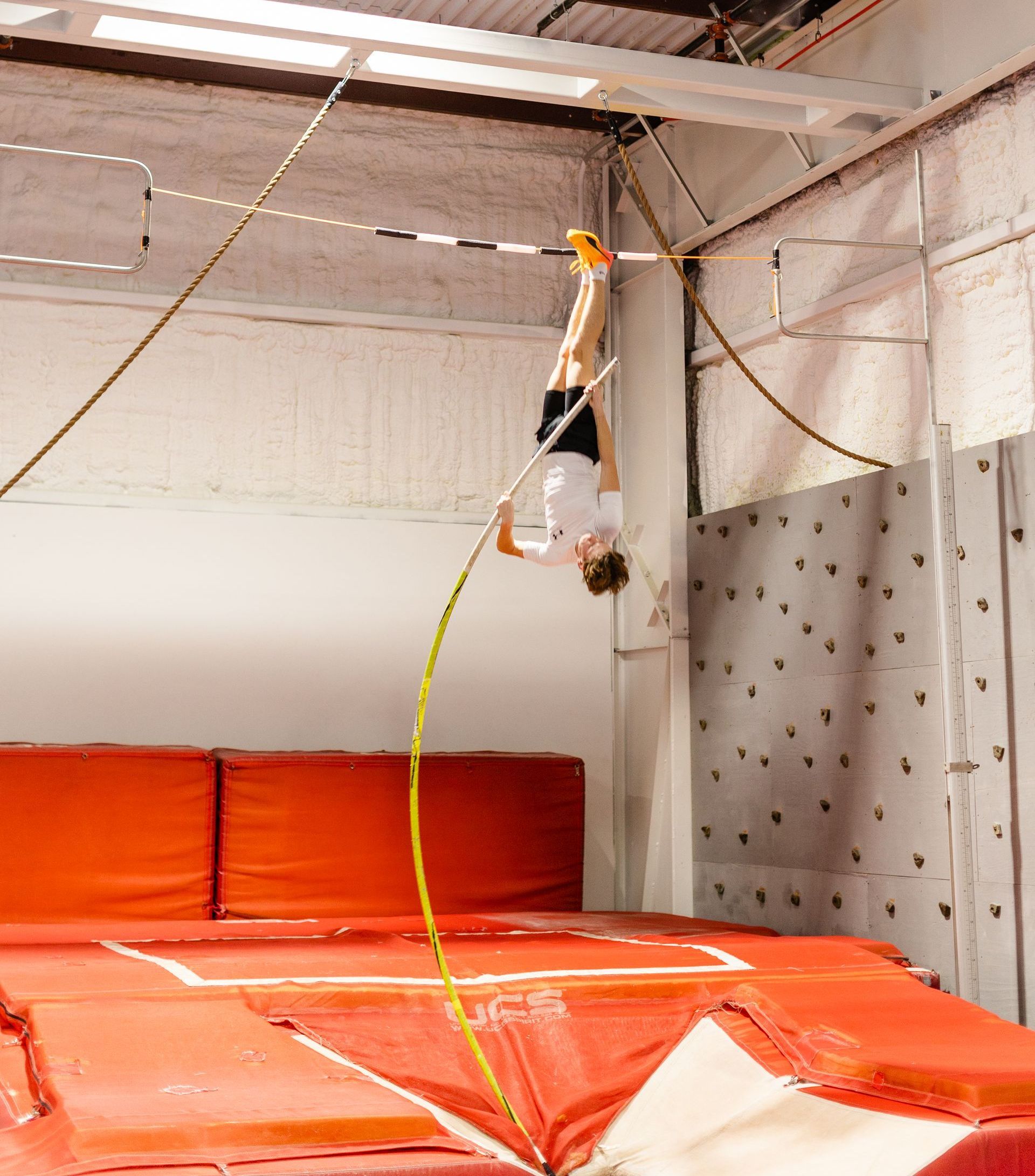 A person is doing a handstand on a trampoline