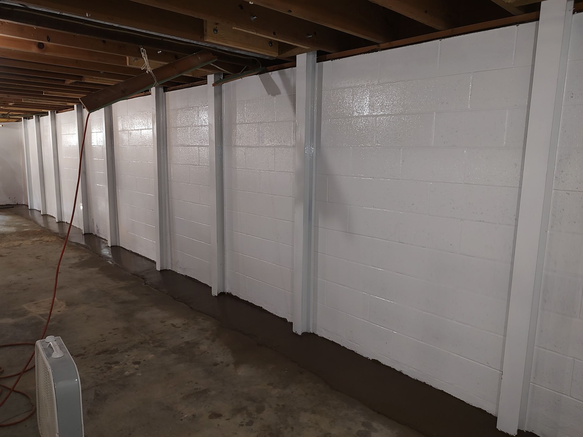 A row of white brick walls in a basement.