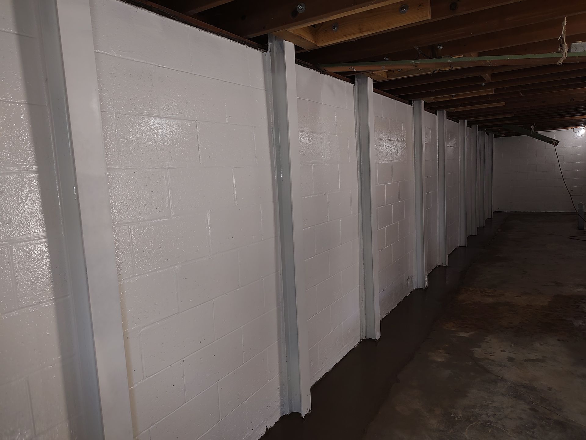 A living room with a couch , table , and window.
