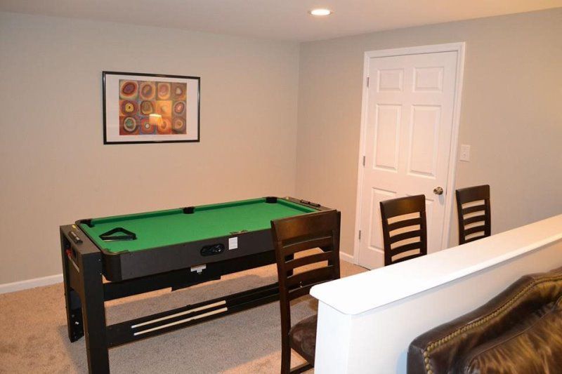A living room with a couch , table , and window.