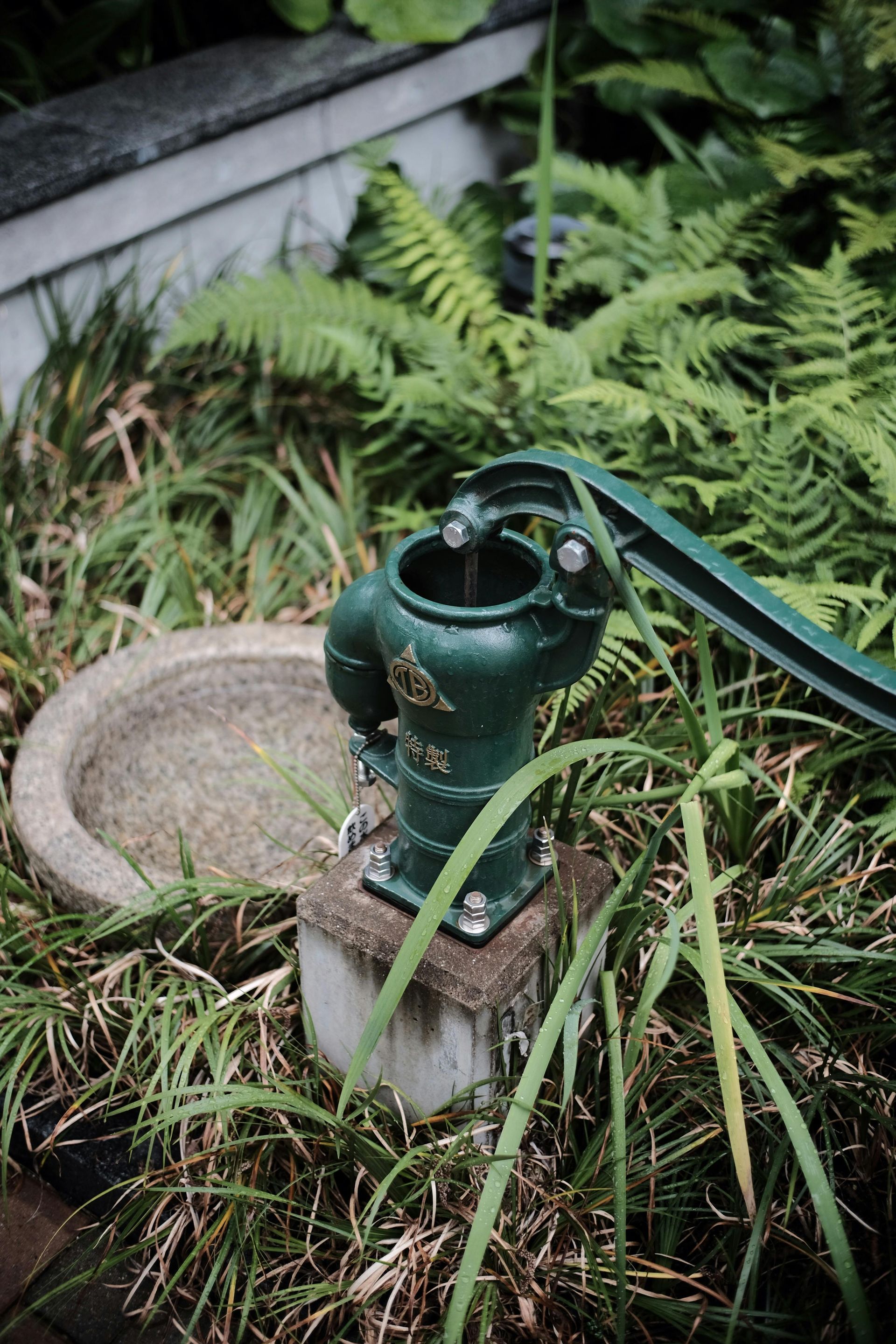 A kitchen with hardwood floors , white cabinets , and stainless steel appliances.
