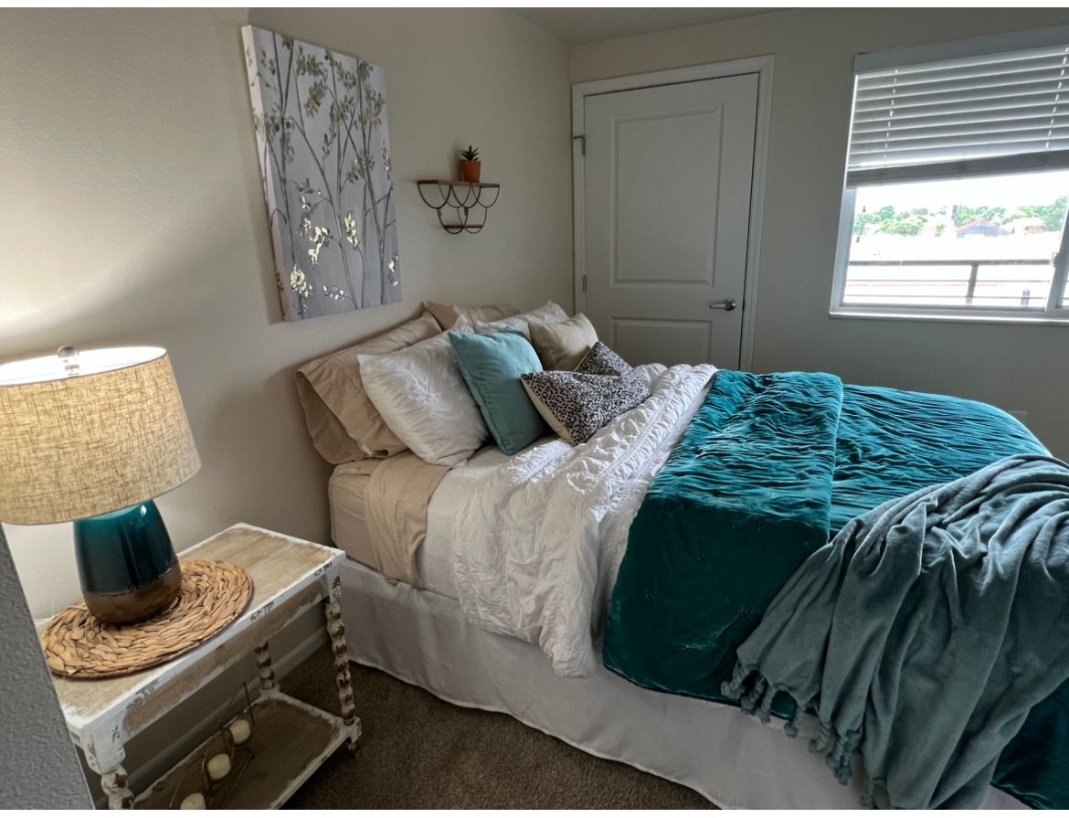 teal comforter set in cool toned room