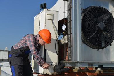 Man doing air conditioning repair — Commercial Air Conditioning in New Port, OR