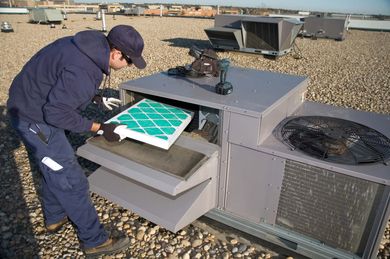 Inspecting roof top unit — Refrigeration Experts in New Port, OR