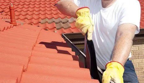 A man clearing out gutters