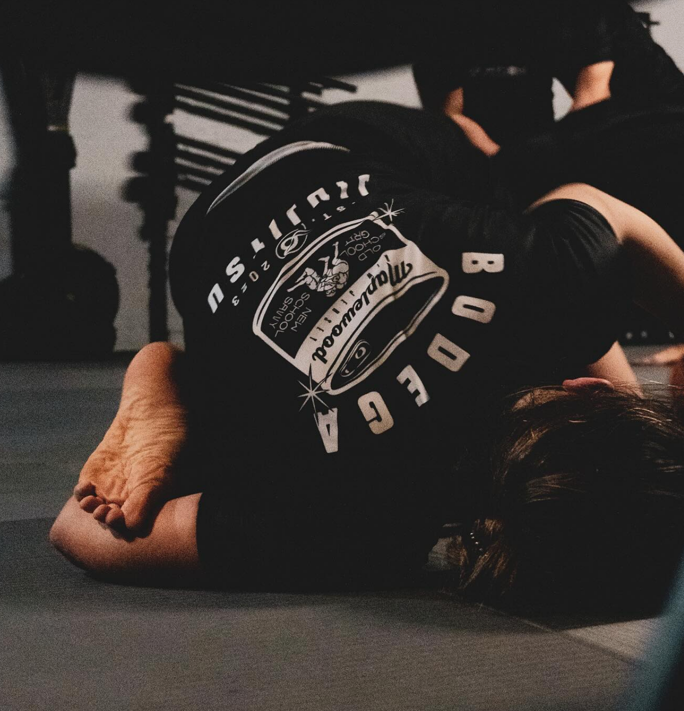 Adults practicing controlled grappling drills at Bodega Jiu-Jitsu in Maplewood, NJ for practical self-defense skills.