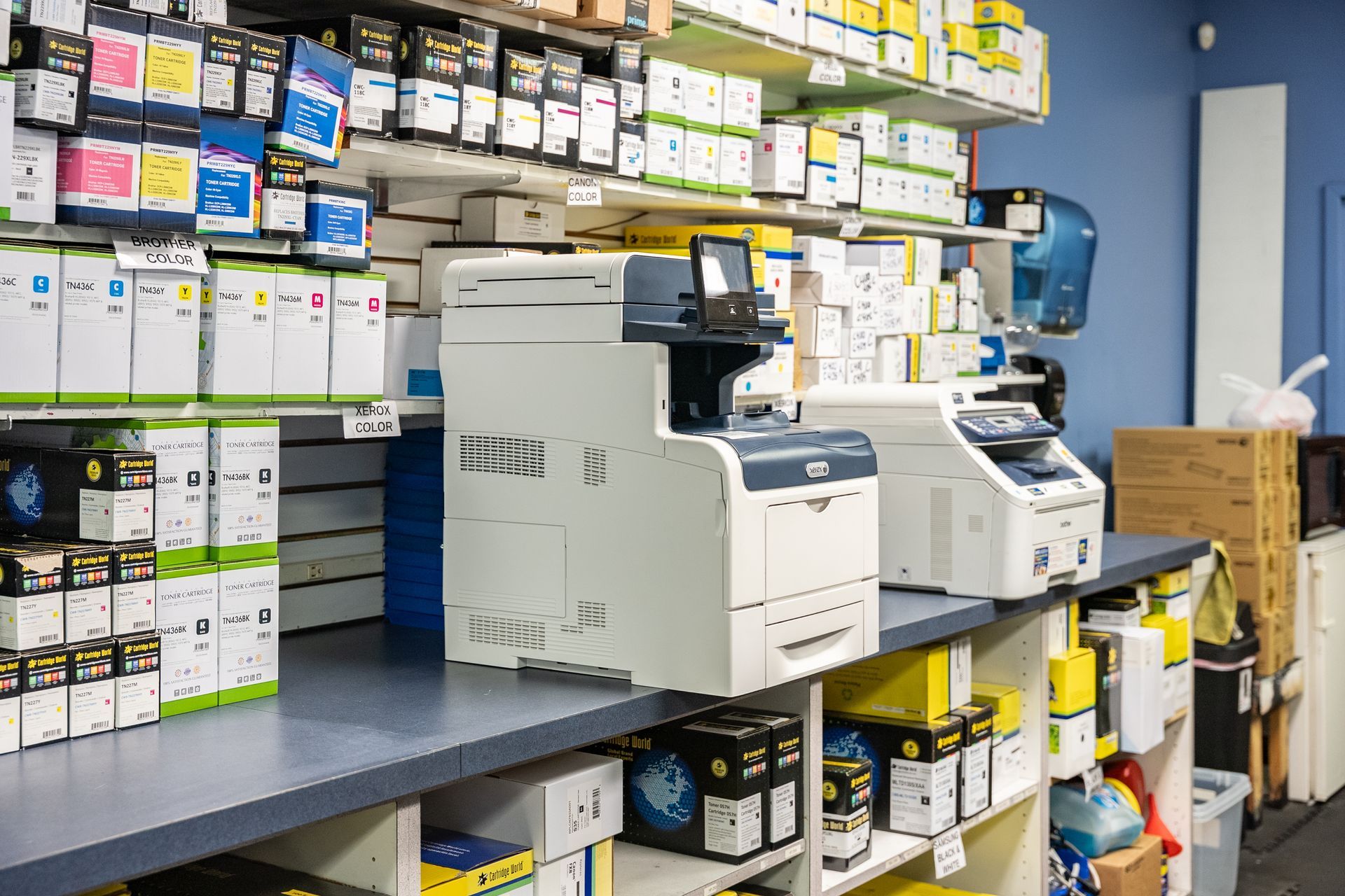 A man is using a printer in an office.