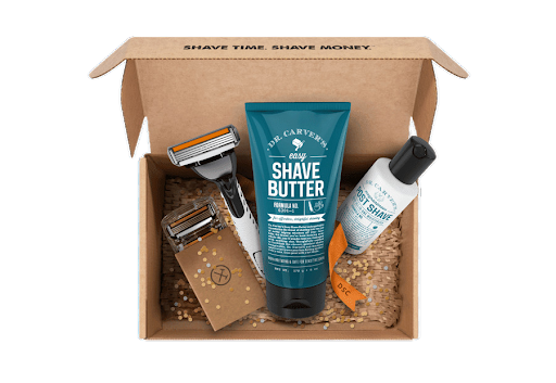 A box filled with a razor , shave butter , and lotion.