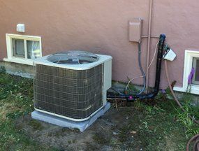 Air Condition Repair — Man Fixing An Air Conditioning Unit in Seattle, WA