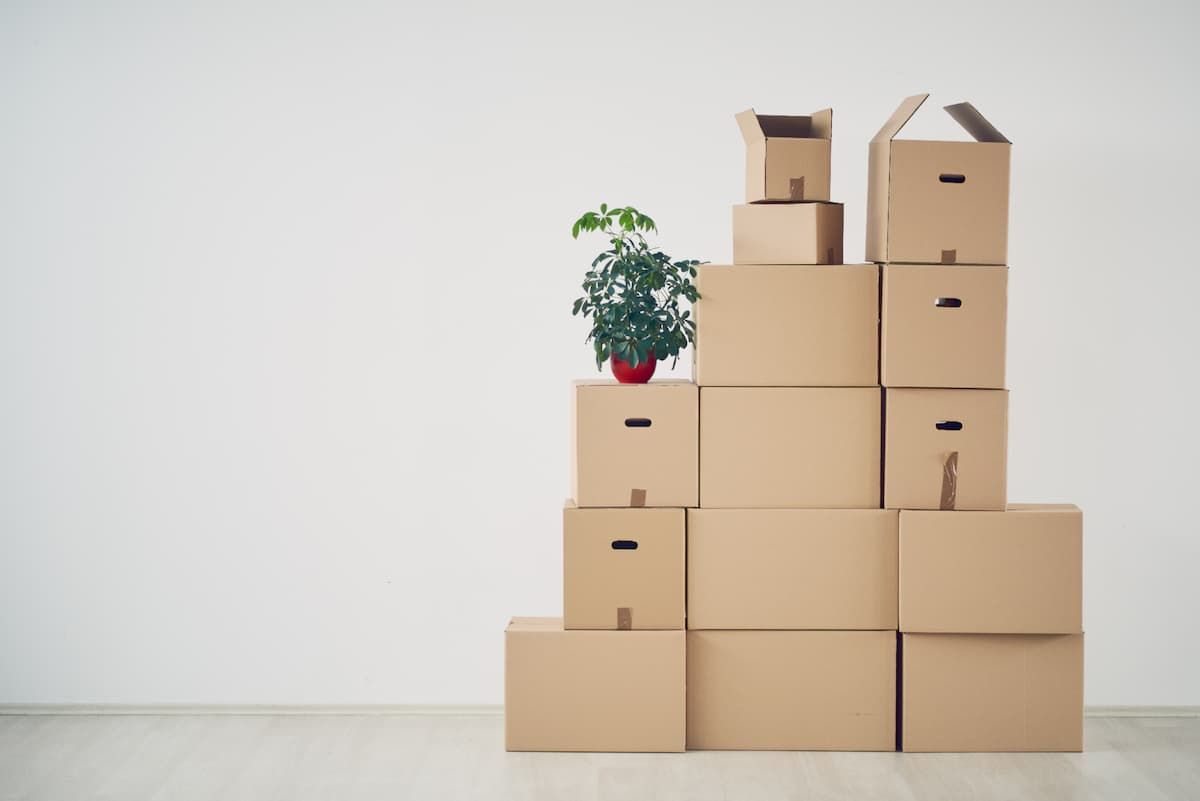 Stack of moxing boxes against a white wall