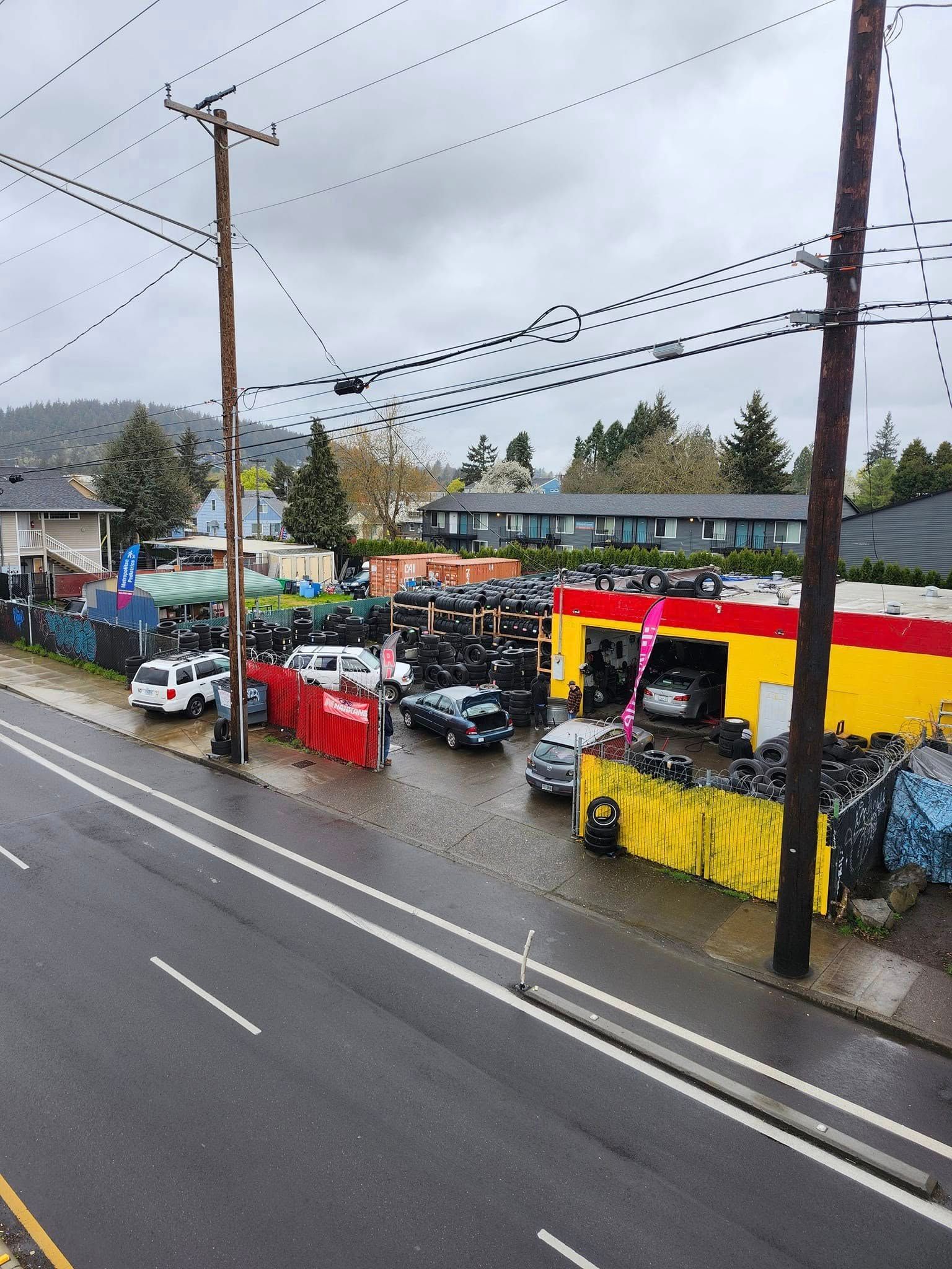 An aerial view of a car dealership on a rainy day