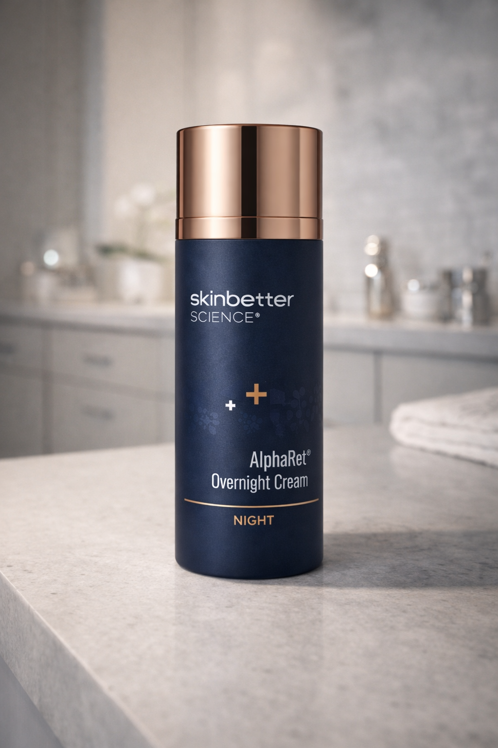 product photograph of a single bottle of Skinbetter Science AlphaRet Overnight Cream sitting on a light grey stone surface.