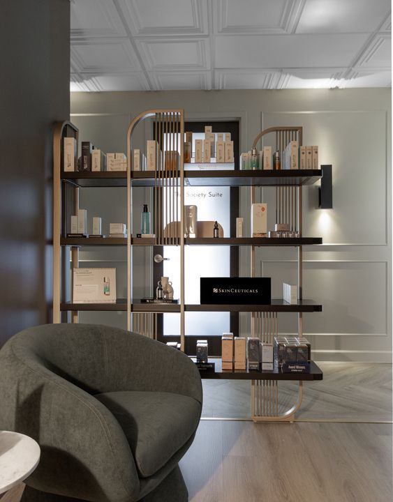 shelving units are neatly stocked with various medical-grade skincare products. One prominent shelf section is filled with the dark blue bottles and boxes of the Skinbetter Science line, next to another section filled with the white and silver packaging of the Alastin Skincare line.