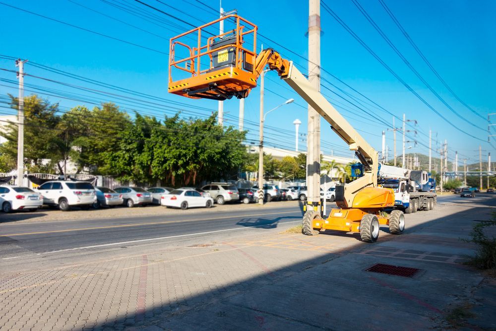 A Crane is Sitting on Top of a Pole in a Parking Lot — FNQ Hot Water In Mareeba, QLD