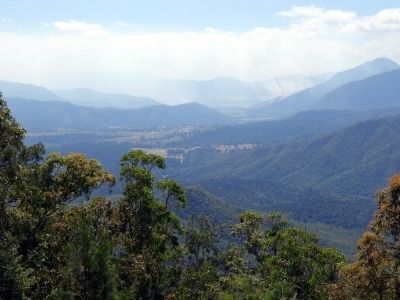 A View of a Mountain Range With Trees in the Foreground and Mountains in the Background — FNQ Hot Water In Atherton, QLD