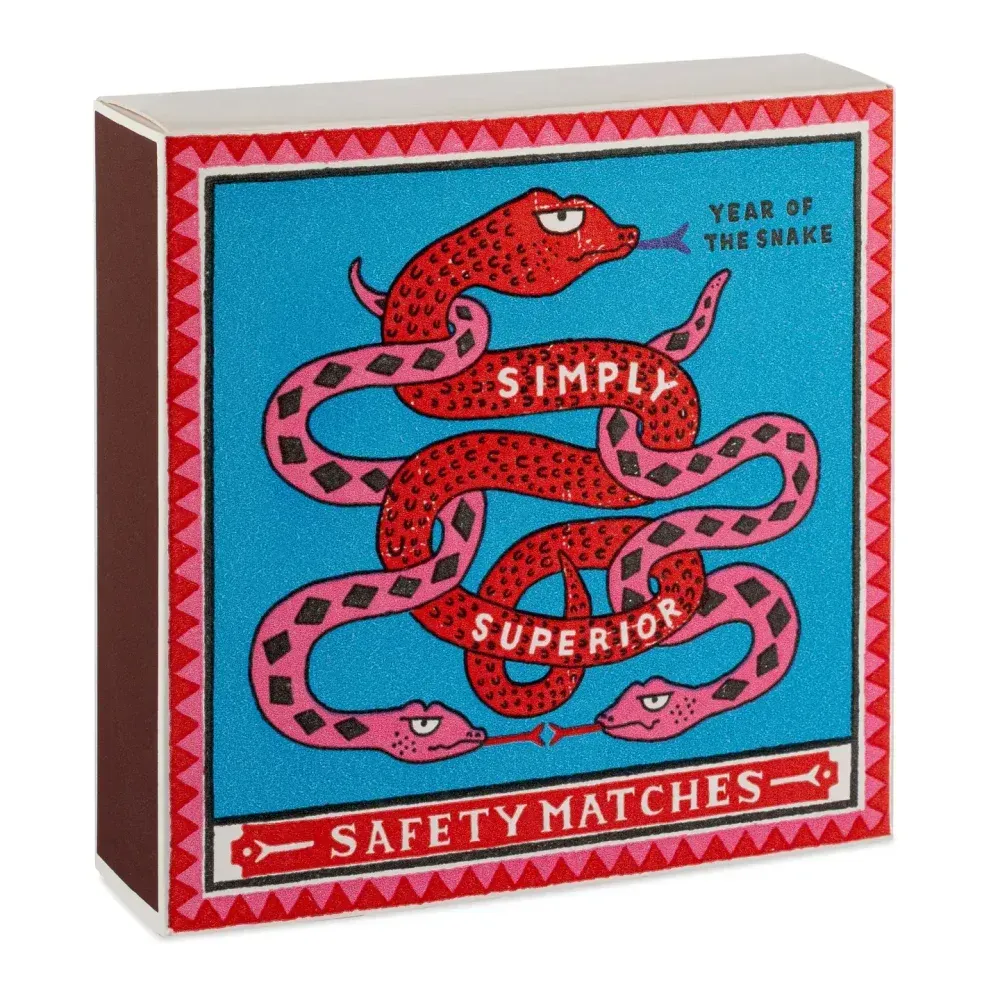 Boîte d'allumettes avec serpents rouges, fond bleu, texte « Allumettes de sécurité Simply Superior ».