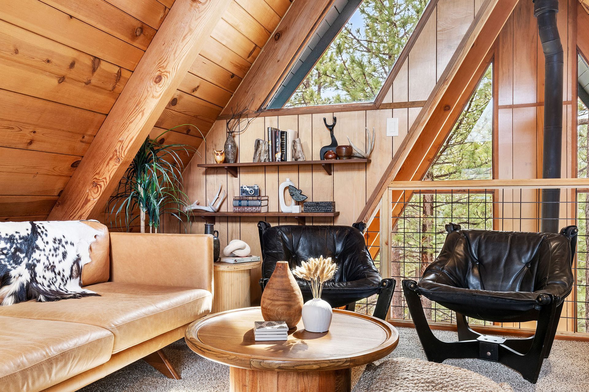A living room with a couch , chairs , and a coffee table.