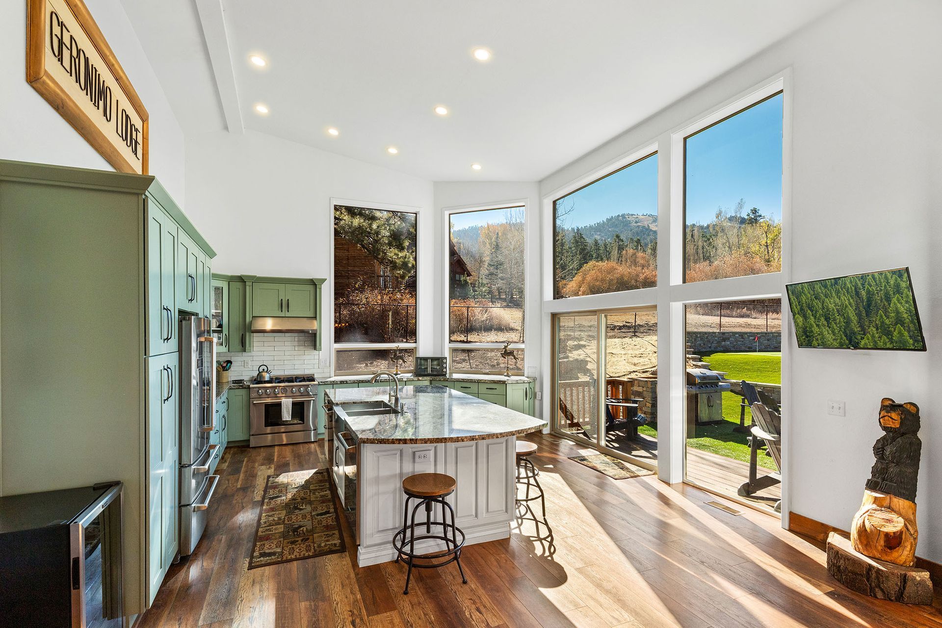 A kitchen with a large island and lots of windows