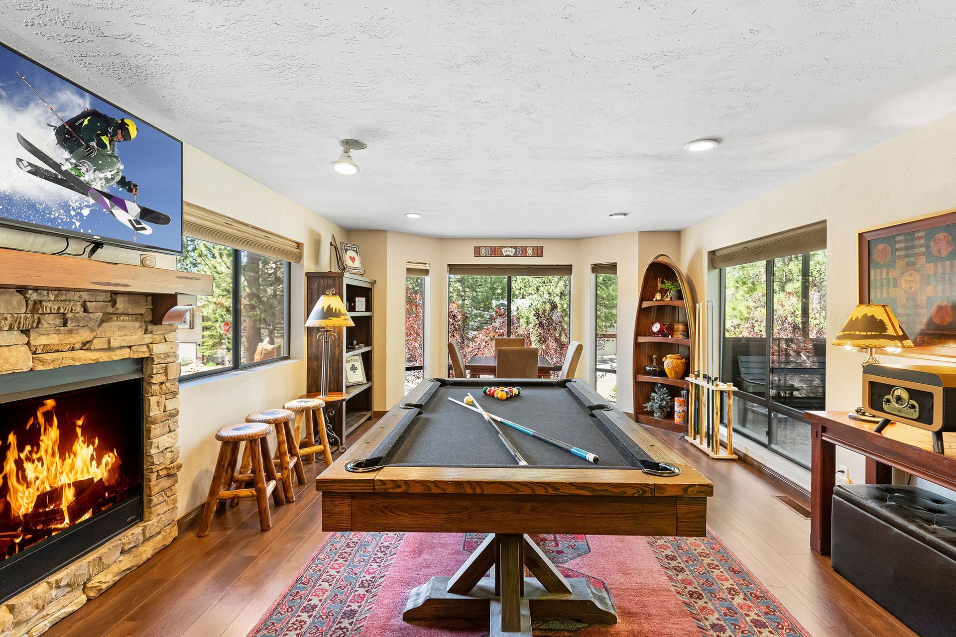 A living room with a pool table and a fireplace