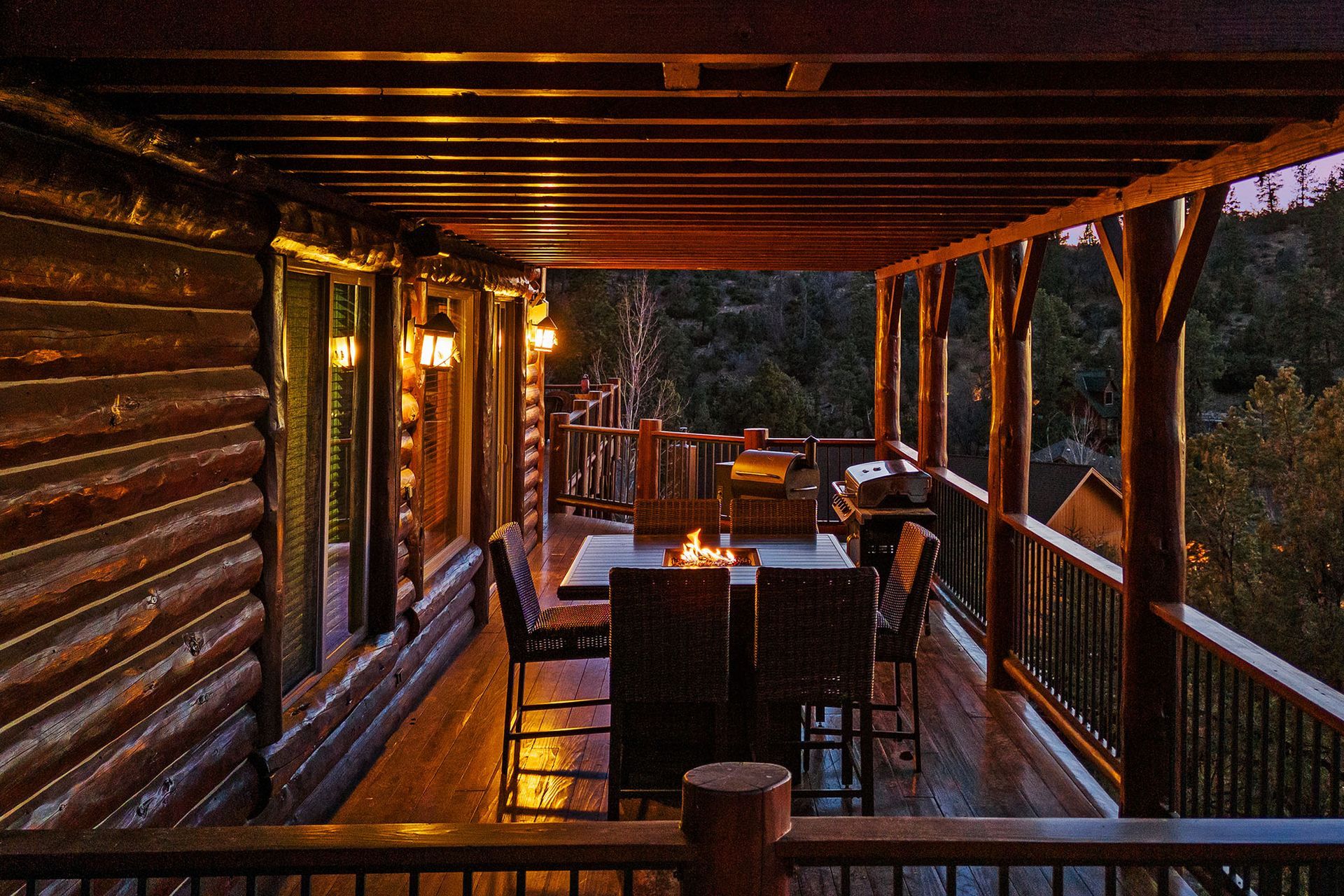 A wooden deck with a table and chairs on it