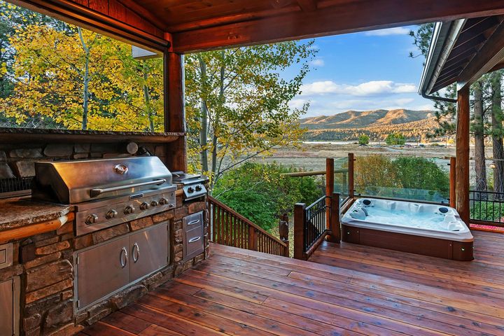 There is a hot tub and a grill on the deck.