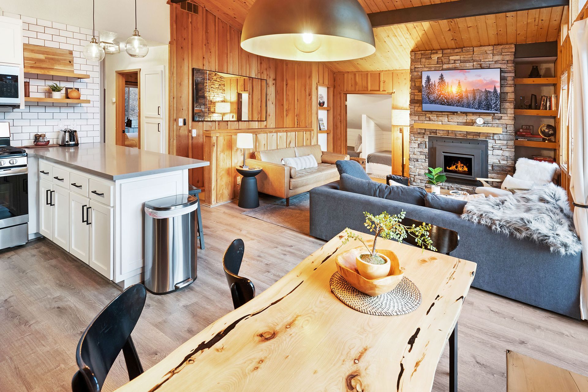 A living room with a dining table , couch , and fireplace.