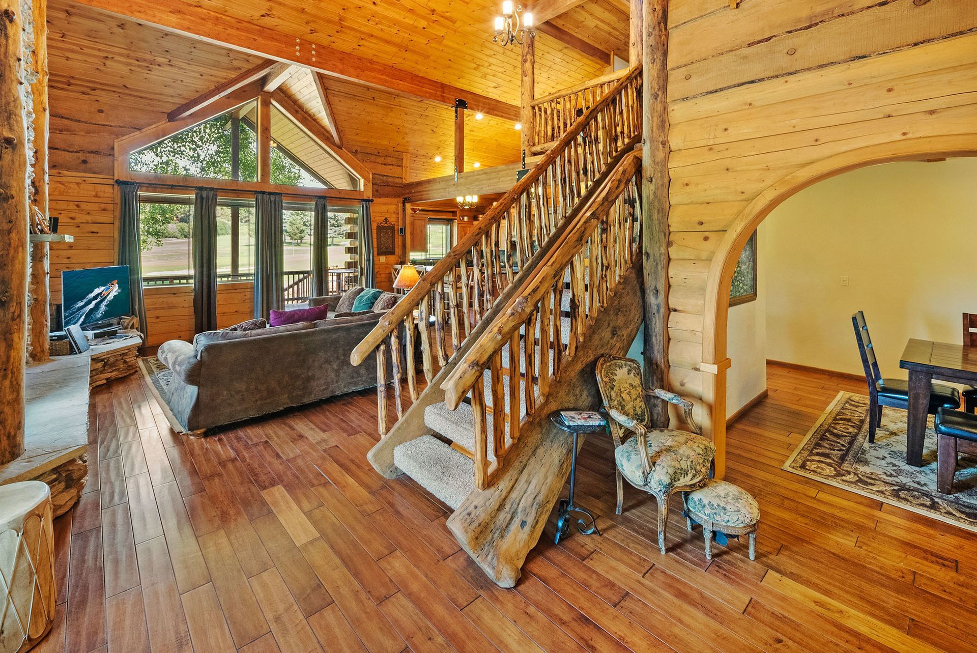 A wooden staircase leading up to the second floor of a log cabin.