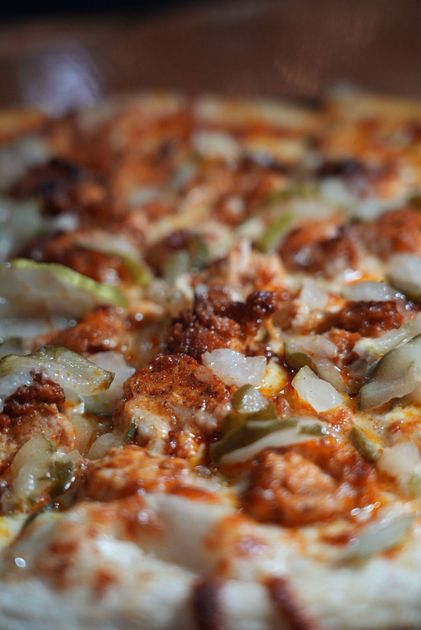 A close up of a pizza with a lot of toppings on it.