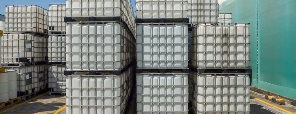 A bunch of plastic containers are stacked on top of each other in a warehouse.