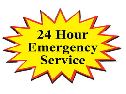 A yellow sign that says 24 hour emergency service