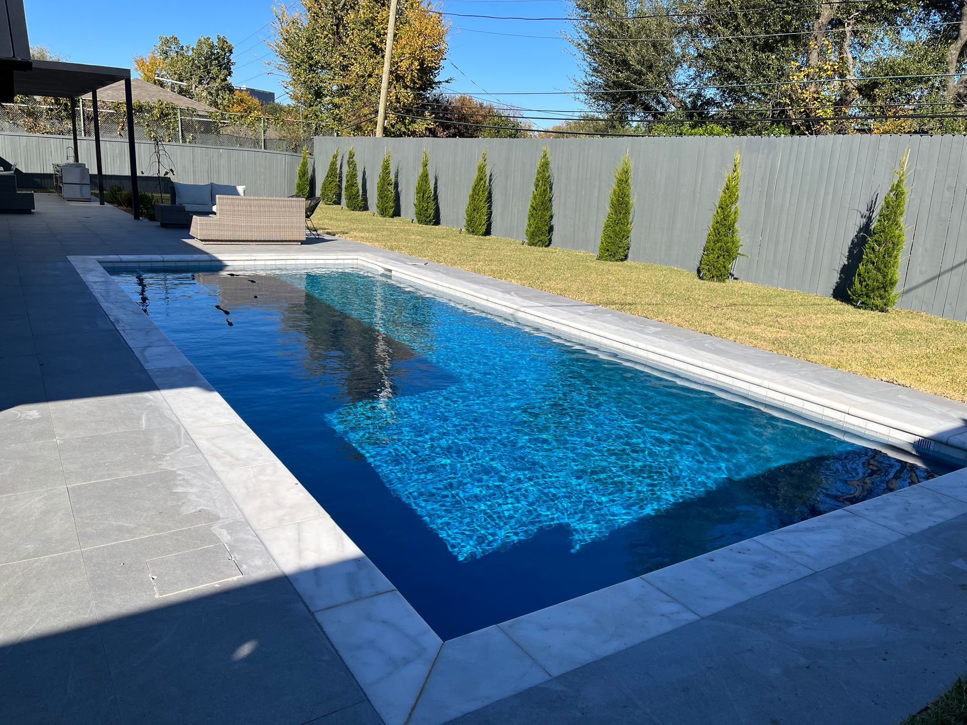 A large swimming pool in the backyard of a house